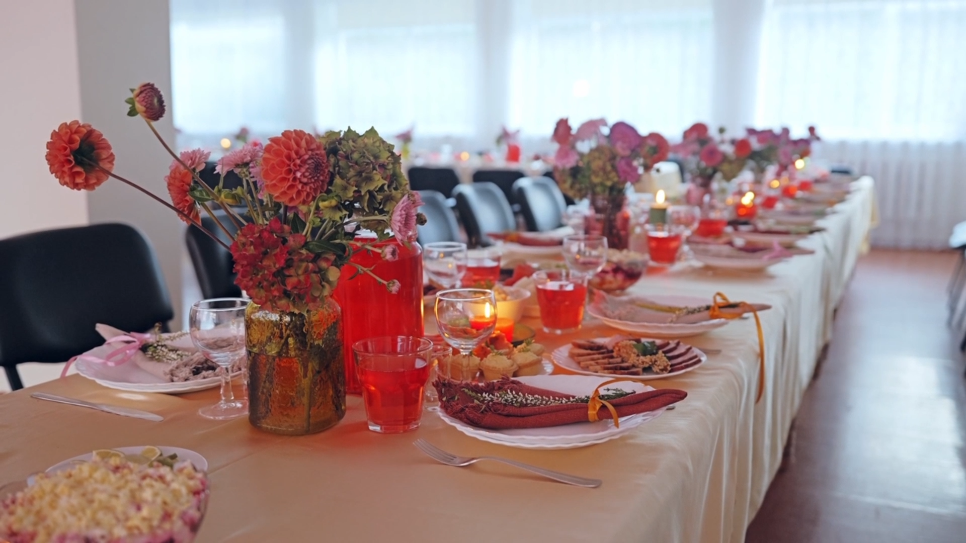 Long dinner table styled with dahlias and candlelight